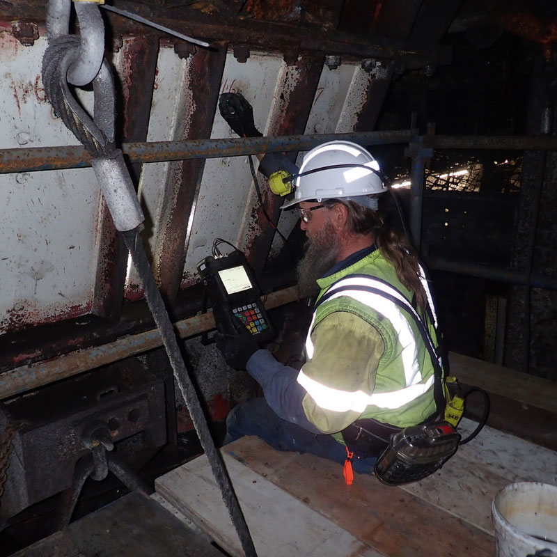 Man inspecting condition of structure