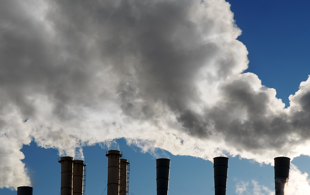 smoke stacks emitting gases - NPI reporting concept