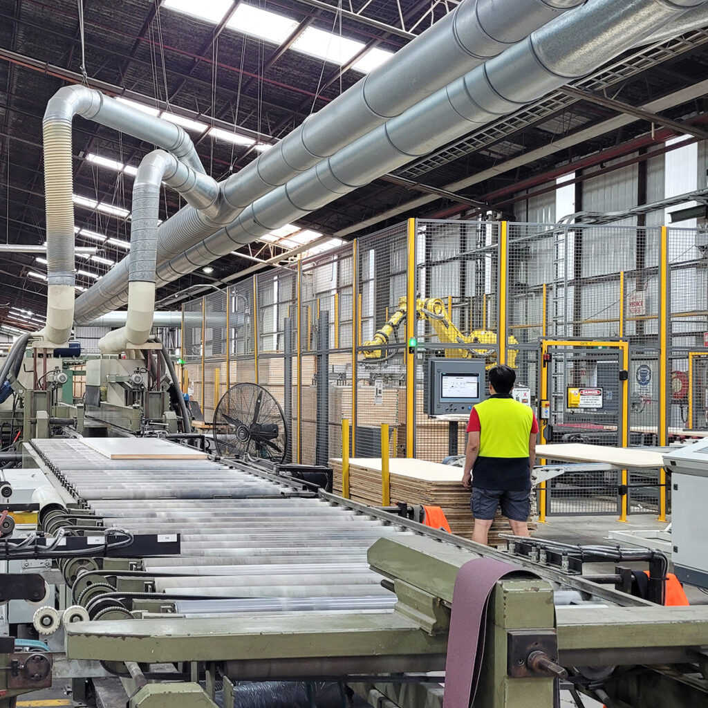 Man in manufacturing facility showing dust extraction infrastructure