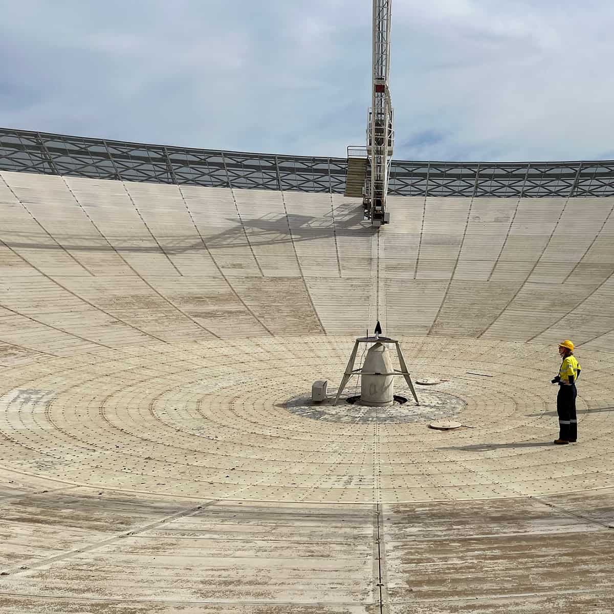 Female engineer inspecting the Parkes Telescope, Australia